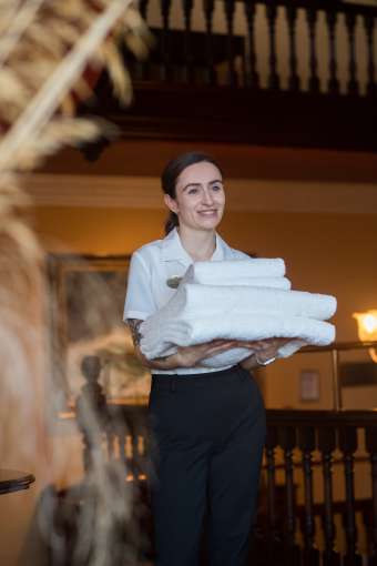 Housekeeping carrying towels in the Imperial Hotel