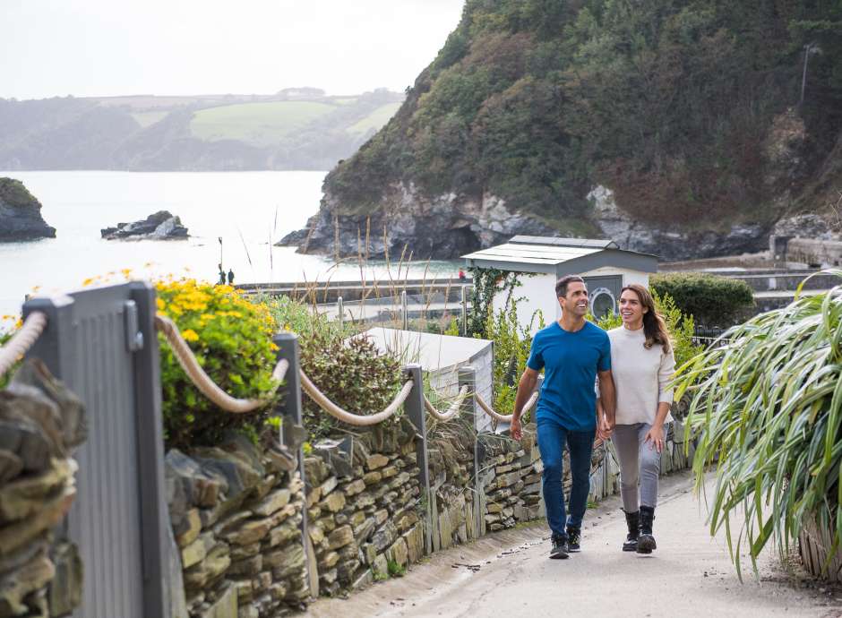 couple walking up path holidaying hands in charlestown