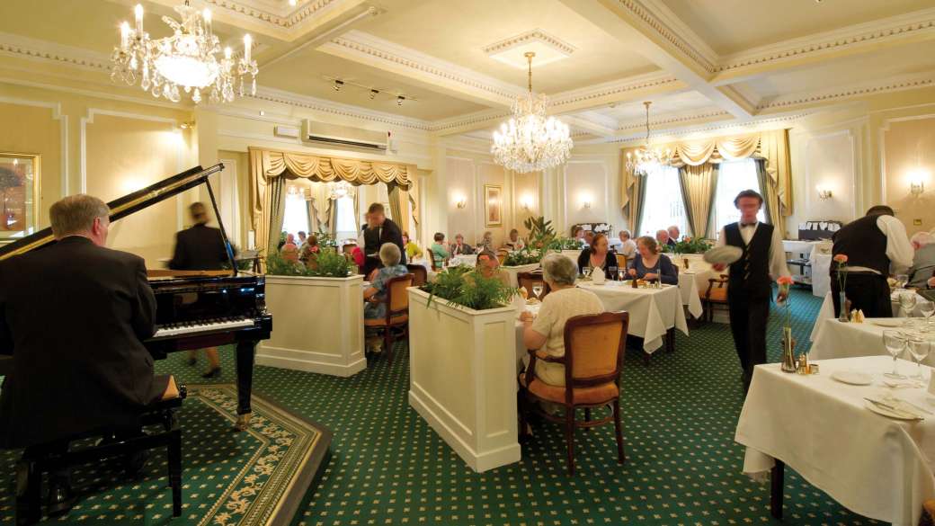 Belmont Hotel Restaurant Dining Area with Pianist and Guests