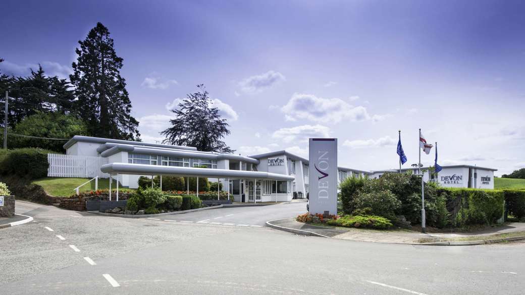 Devon Hotel Exterior with Sign and Flags