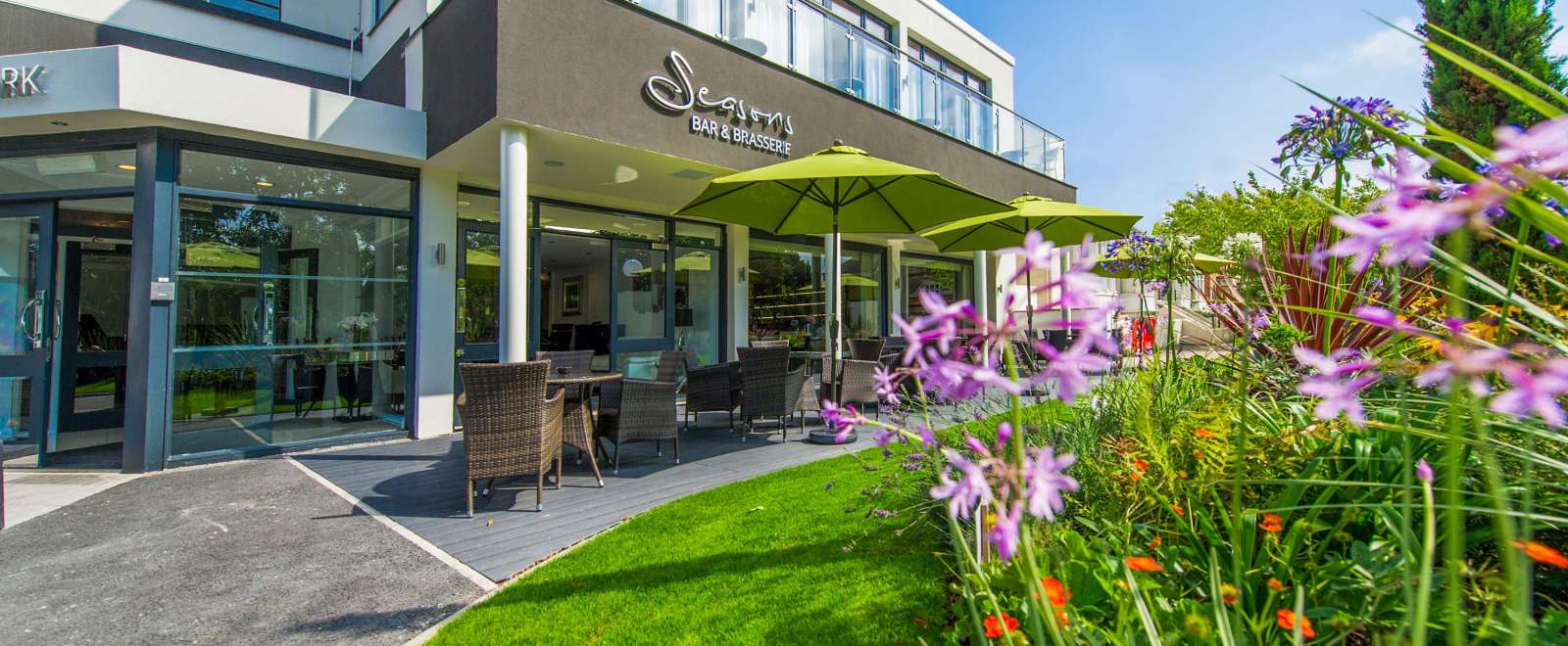 Park Hotel Seasons Bar and Brasserie External View with Outdoor Seating and Flowers
