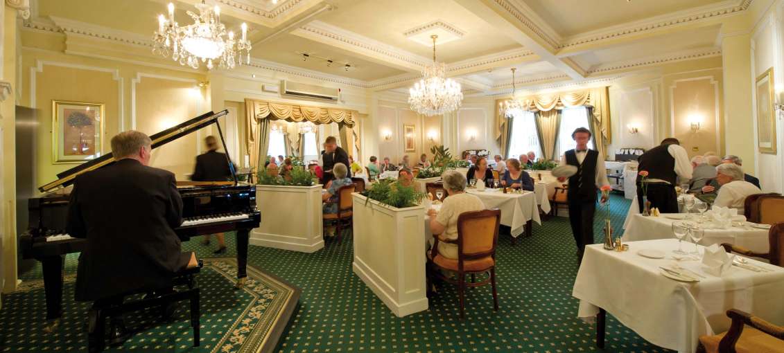 Belmont Hotel Restaurant Dining Area with Pianist and Guests