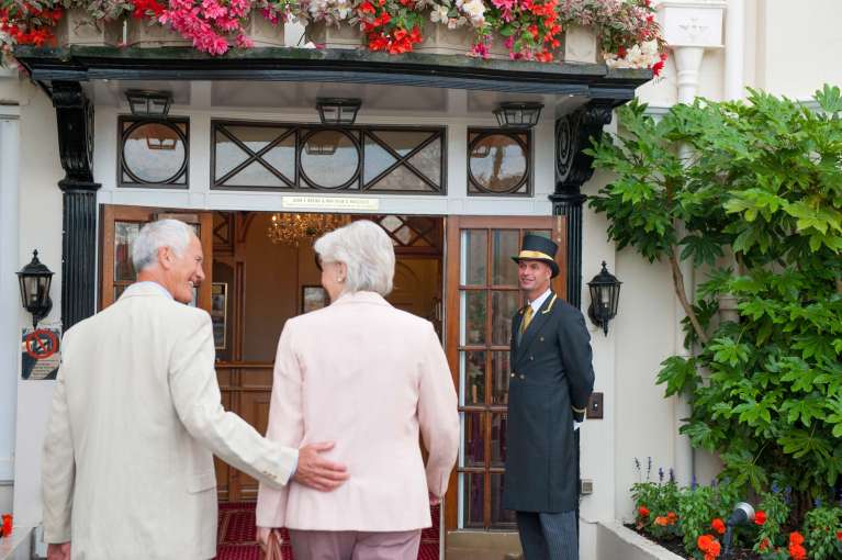 Belmont Hotel Doorman Greets Arriving Guests at Front Door