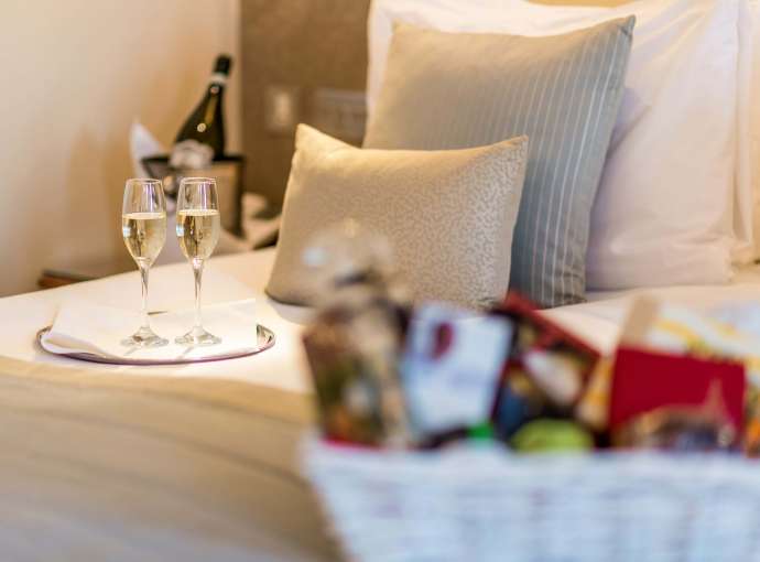 Carlyon Bay Hotel Champagne Flutes and Christmas Hamper on Bed in Room