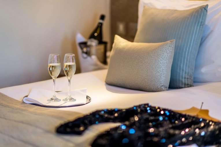 Carlyon Bay Hotel Christmas Party Outfit and Champagne Flutes on Bed