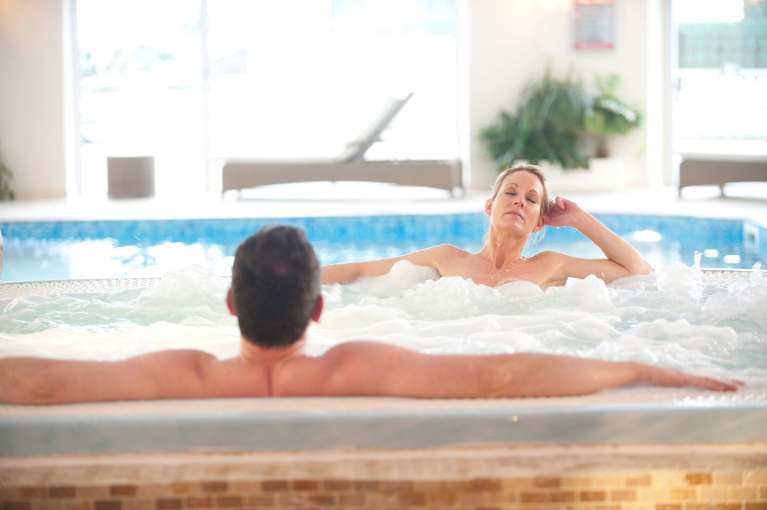 Carlyon Bay Hotel Couple Relaxing in the Jacuzzi Spa Hot Tub