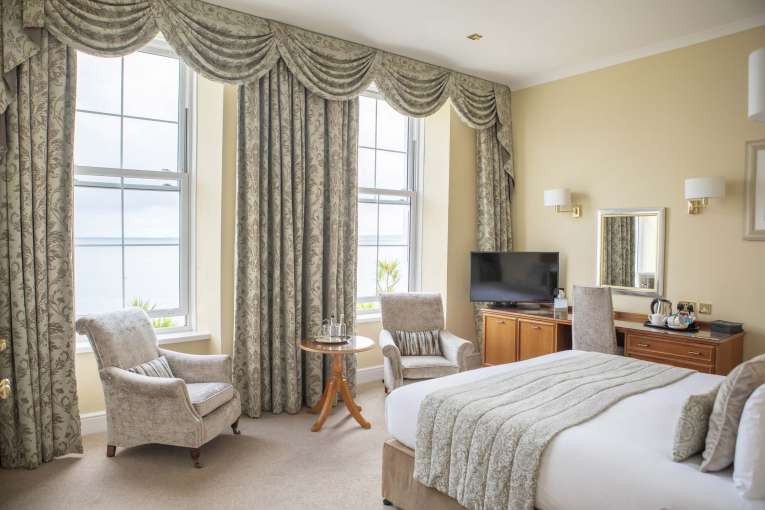 Royal Duchy Hotel Deluxe Sea View Room First Floor Accommodation Bedroom with Seating and Desk