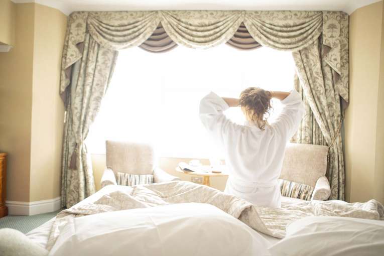 Royal Duchy Hotel Guest Tying up Hair After a Good Nights Sleep