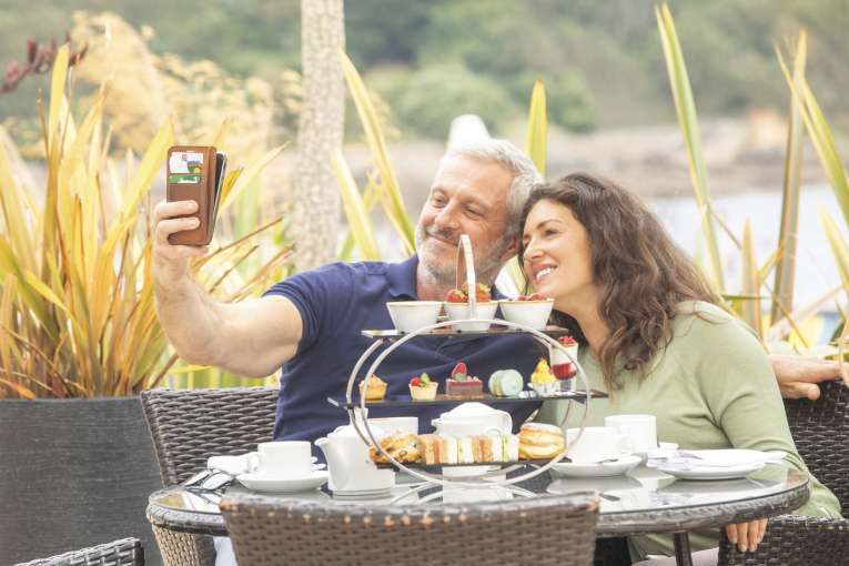 Royal Duchy Hotel Couple Enjoying an Afternoon Tea and Taking a Selfie