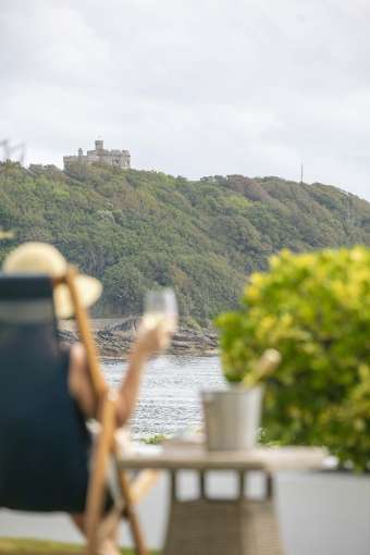 Royal Duchy Hotel Guest in Deck Chair with Wine Looking Out at Pendennis