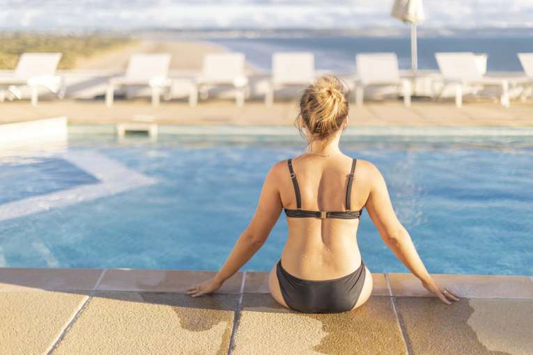 Saunton Sands Hotel Guest Sitting by Outdoor Pool Enjoying View Over Saunton Beach