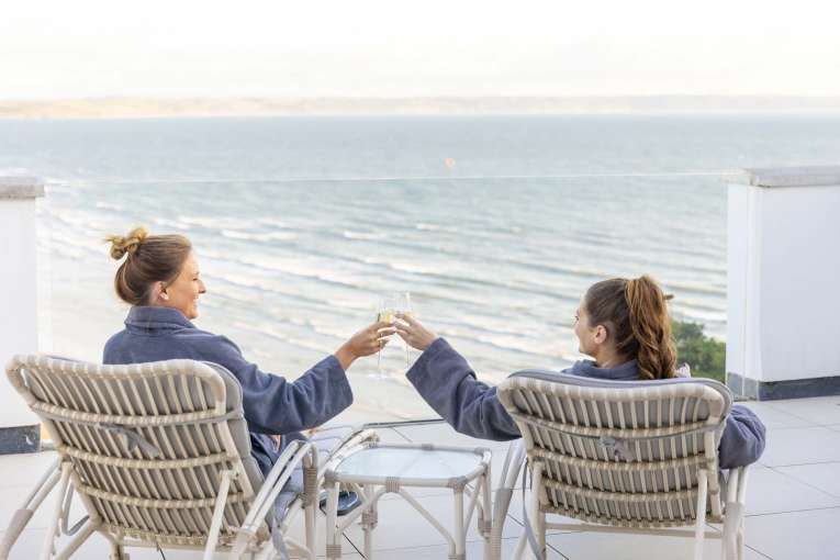 Saunton Sands Hotel Source Spa Guests on Sun Deck Toasting with Champagne Flutes Overlooking the Sea