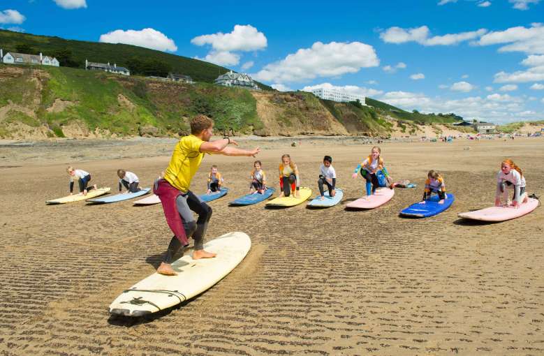 Saunton Sands Hotel Saunton Beach Surf Instructor Teaching Children with Hotel in Background