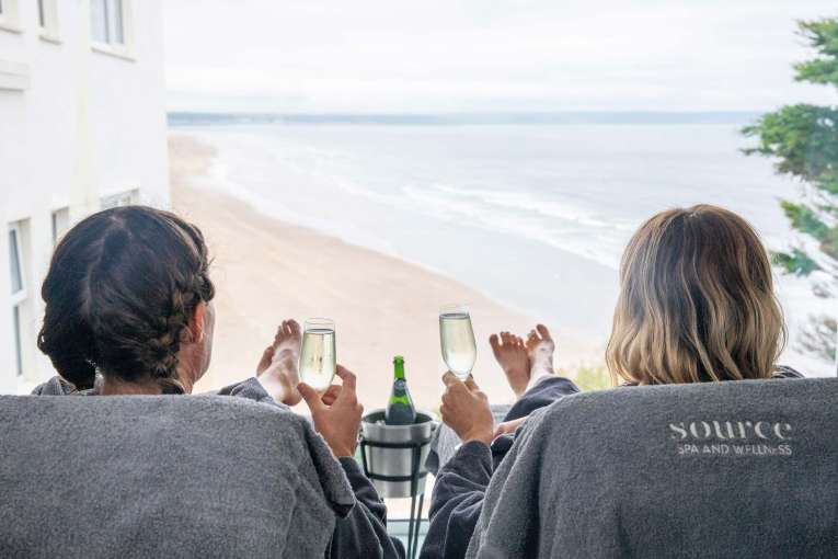 Saunton Sands Hotel Source Spa Guests Enjoying Prosecco in Treatment Room and Looking at View Over Saunton Beach from Window