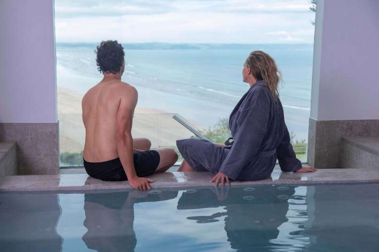 Saunton Sands Hotel Source Spa Couple Sitting on Edge of Vitality Pool Hot Tub Enjoying the View Over Saunton Beach