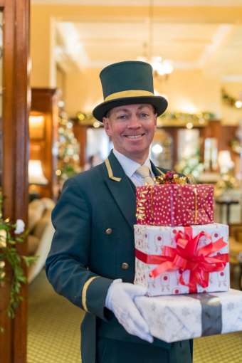 Victoria Hotel Doorman Carrying Christmas Presents