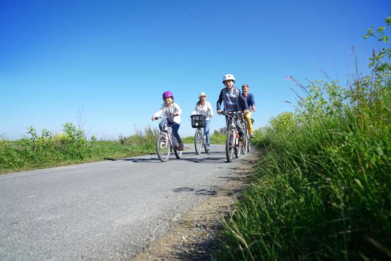 A family cycling on a country lane