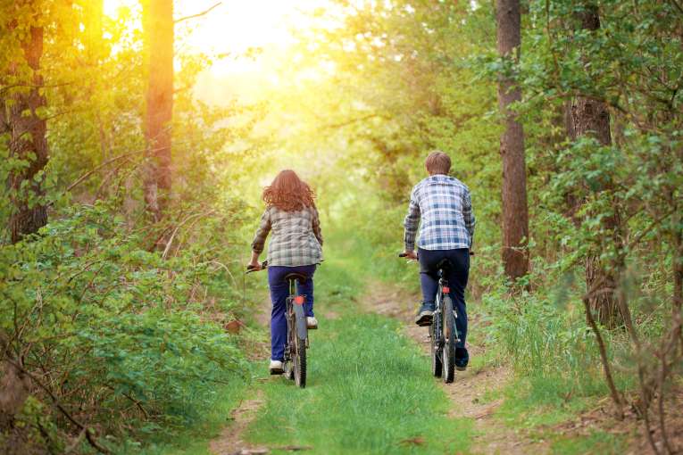 A couple cycling down a country lane