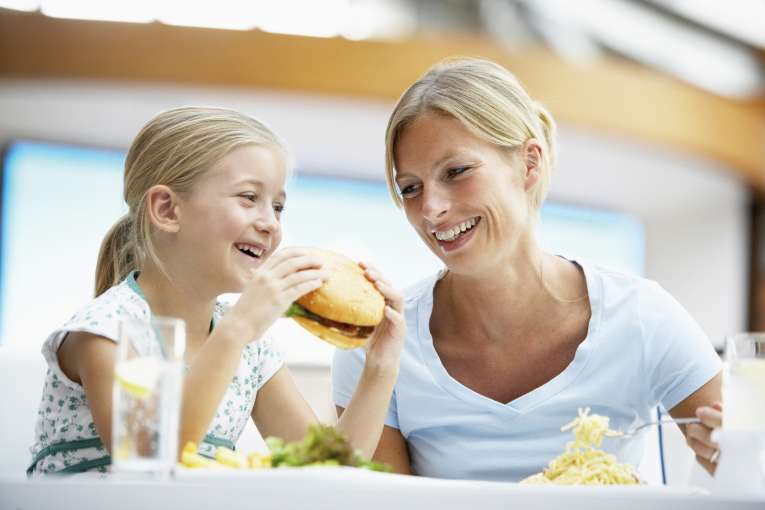 Mother and daughter eating in restaurant