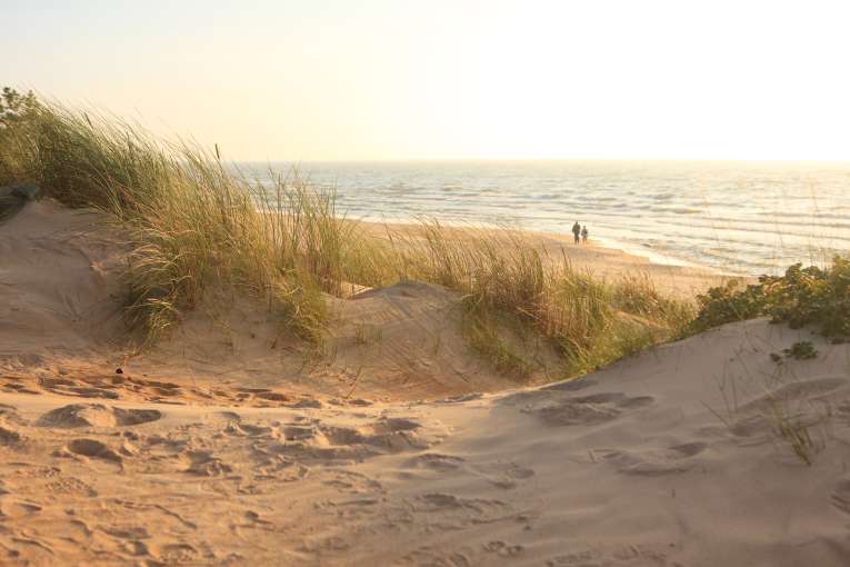 A winter beach at sunset with people in the distance