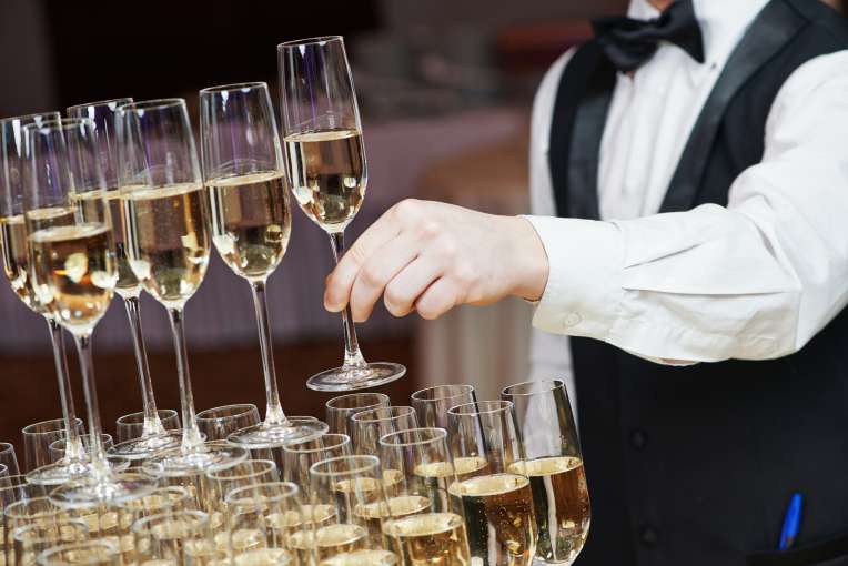 Waiter making a Champagne fountain at a Wedding Reception