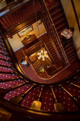 Stairway at The Imperial Hotel with housekeeping walking up