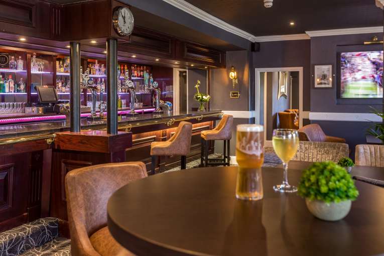 Devon Hotel carriages bar and brasserie bar area with pint and wine