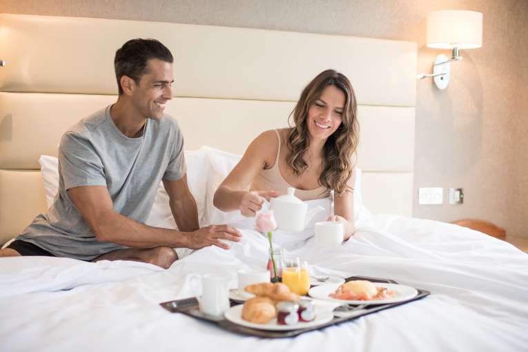 carlyon bay couple having breakfast in bed