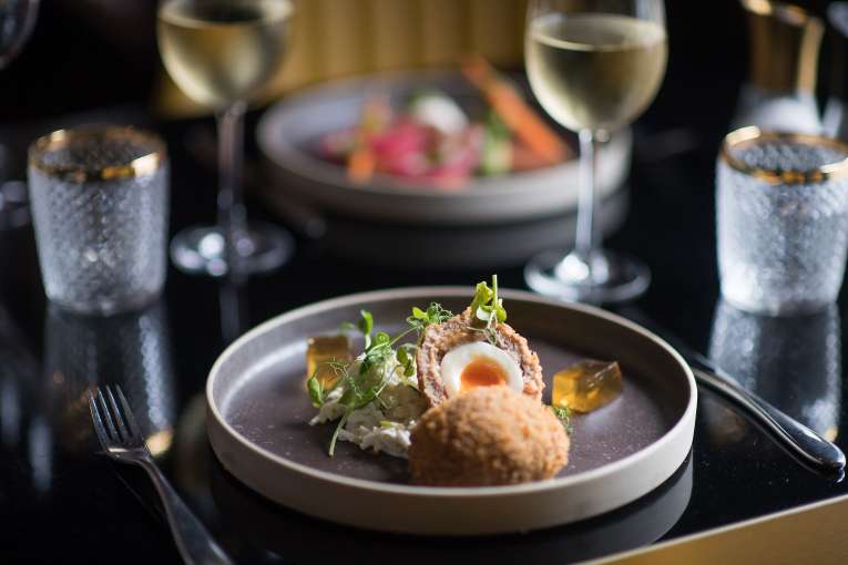 scotch egg and salmon starter in background