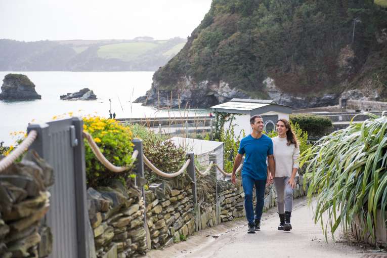 couple walking up path holidaying hands in charlestown