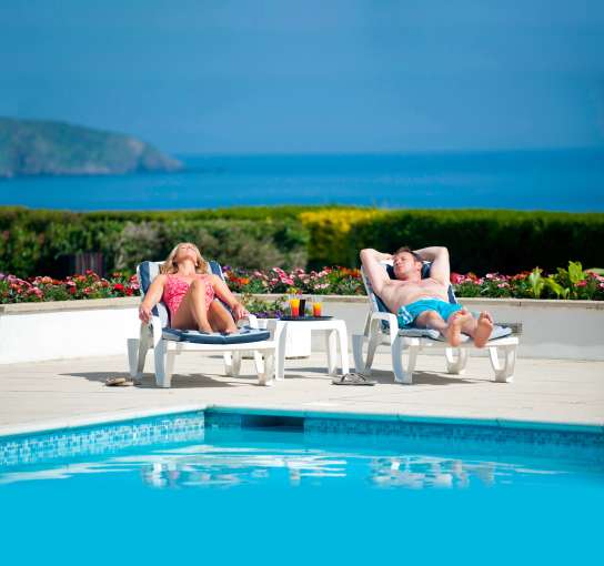 Couple sun bathing at carlyon bay hotel