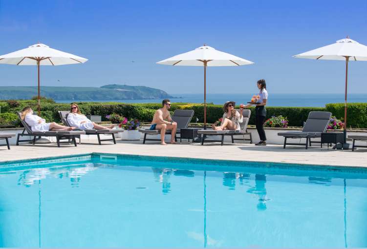 carlyon bay outdoor pool with people being served drinks