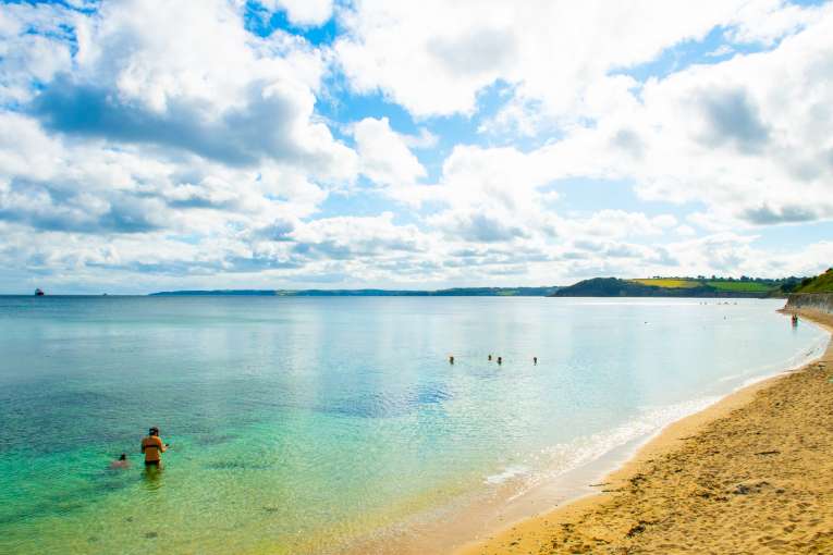 People swimming in Castle Beach Falmouth