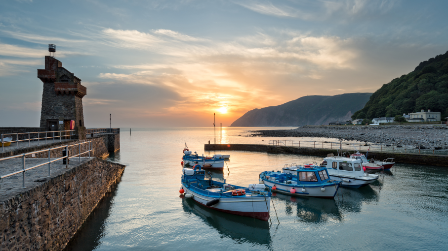 Boats mored at Lynmouth Harbour at sunset