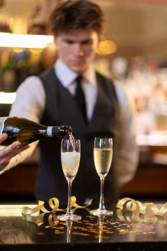 Staff Member Serving Prosecco at Bertie's Bar