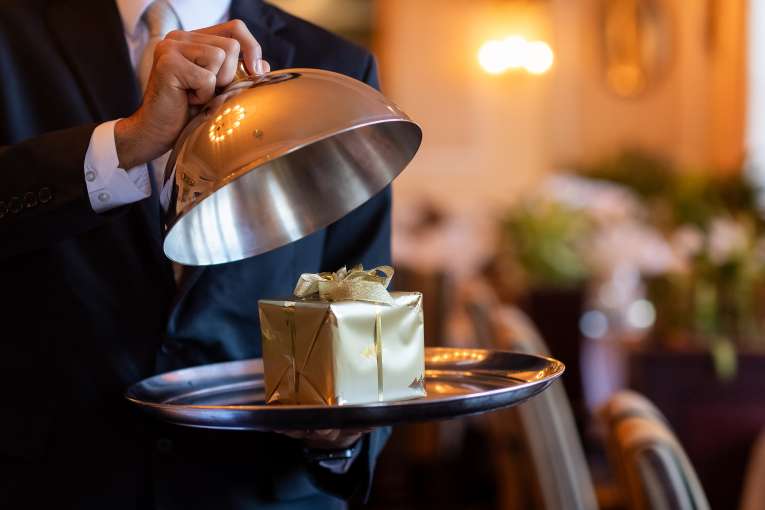 Restaurant Staff Opening Cloche to Reveal Christmas Gift