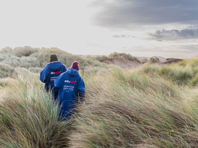 Couple walking along Saunton Sands
