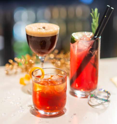 Three festive cocktails on bar