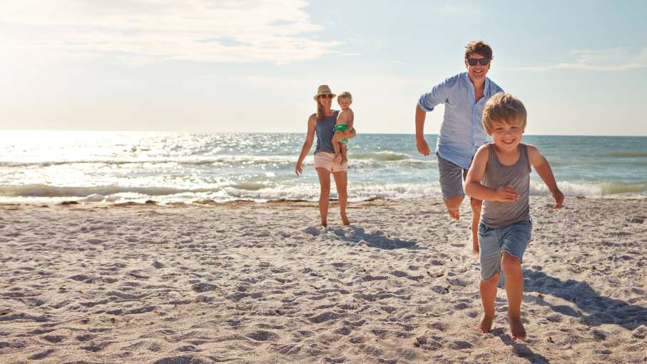 Family running on beach