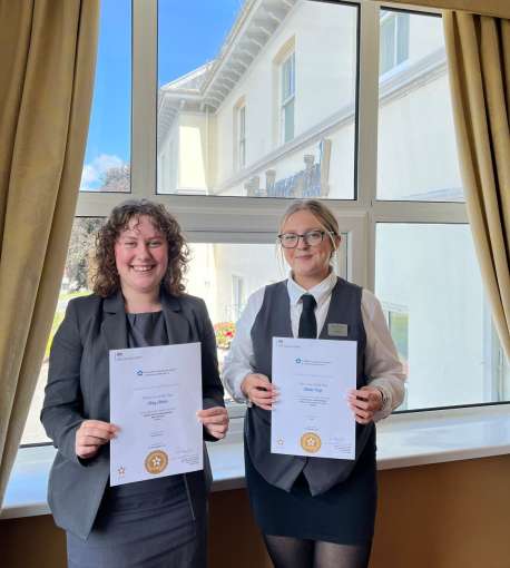 2 girls holding apprenticeship certificates 