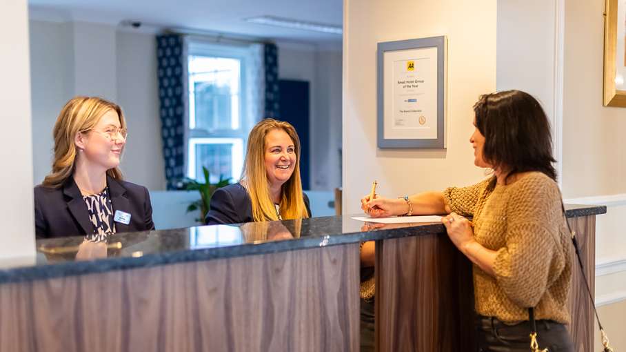 Woman checking in at the reception at Carlyon Bay Hotel