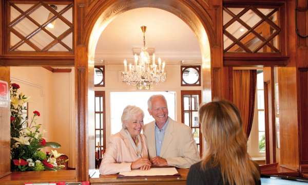 Belmont Hotel Happy Guests Arriving at Reception Desk