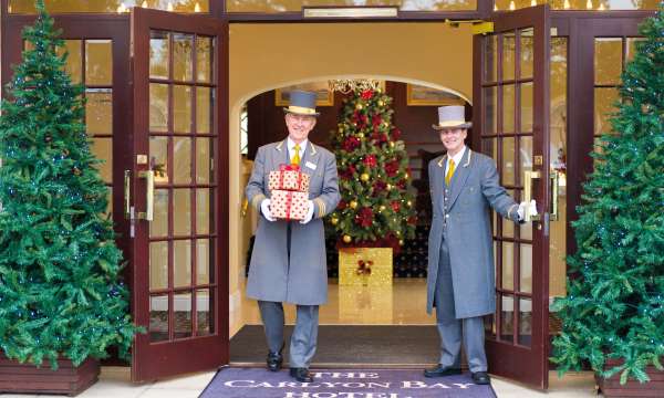 Carlyon Bay Hotel Doorman Carrying Christmas Presents at Hotel Entrance