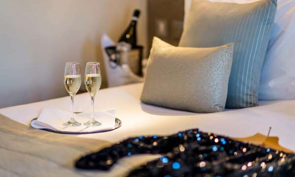 Carlyon Bay Hotel Christmas Party Outfit and Champagne Flutes on Bed