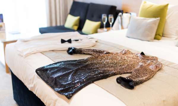 Park Hotel Christmas Party Outfits on Bed with Champagne on Table