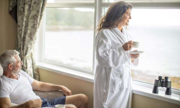 Royal Duchy Hotel Couple Enjoying View from Bedroom Window with Coffee