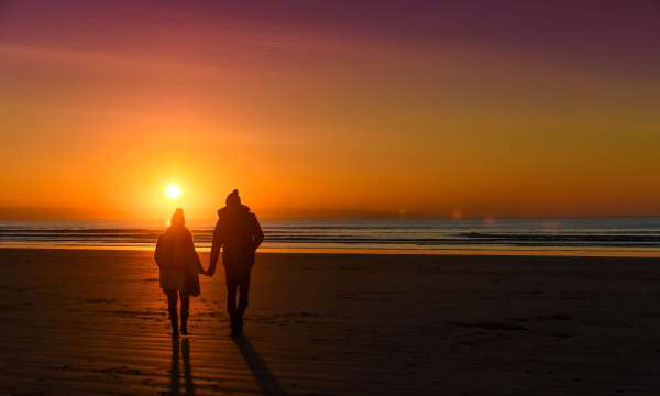 Saunton Sands Hotel Couple Walking Along Saunton Beach at Sunset in Winter