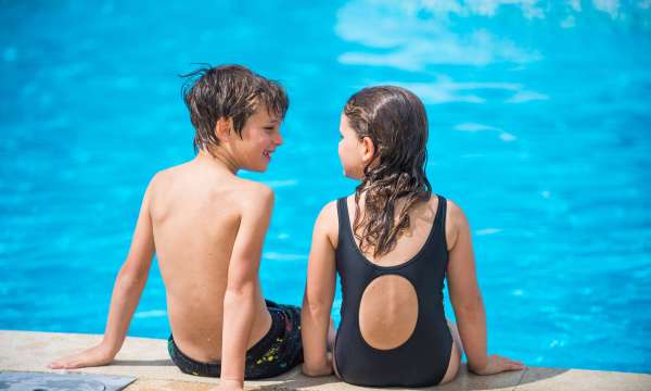 Victoria Hotel Children Sitting on Edge of Outdoor Pool