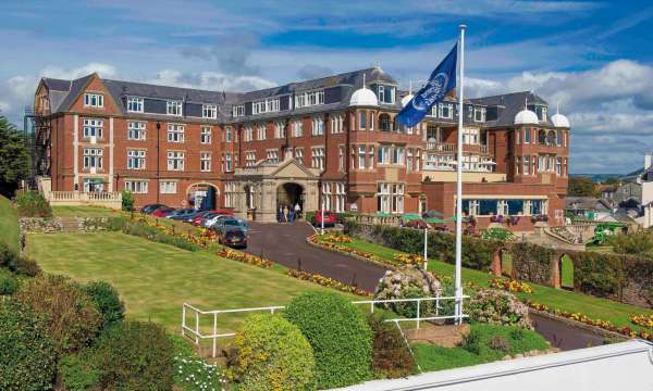Victoria Hotel External View with Flag and Gardens
