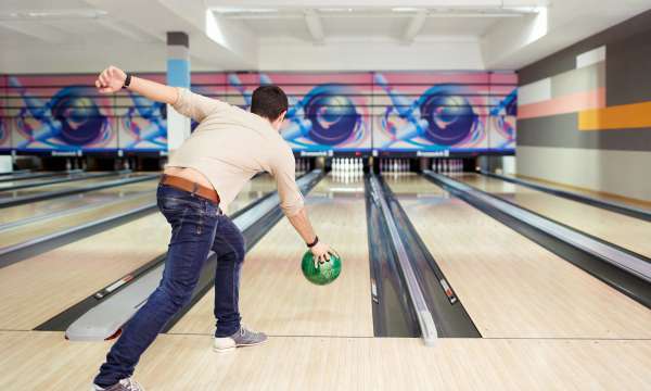 A man about to bowl for a strike at ten pin bowling